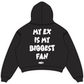 Black oversized cropped hoodie back view with centered white bold bubble lettering reading MY EX IS MY BIGGEST FAN and NWAYTA oval logo badge below, padded on white square canvas